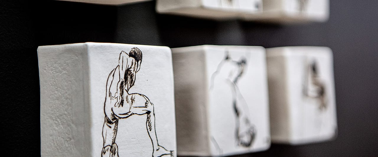 Close detail of the figure studies on ceramic blocks in the practice.