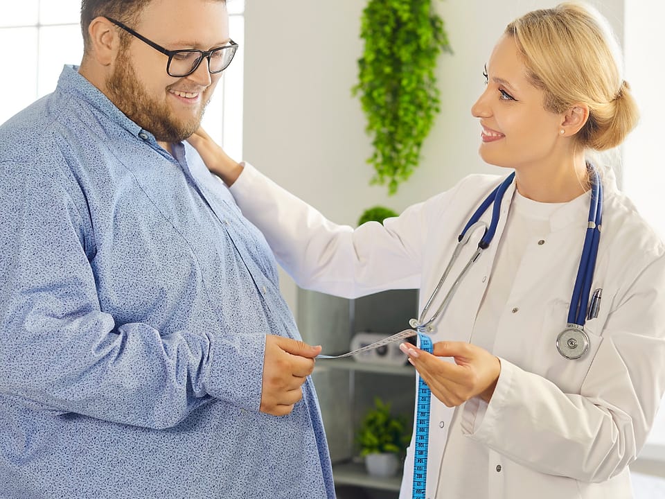 An Obesity Health Centre clinician measuring a patient with a tape measure during an assessment.