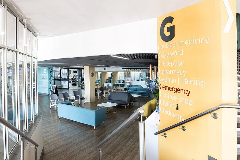 The main entrance and reception concourse at Zuid-Afrikaans Hospital, with wayfinding signage to reception, pharmacy and the day ward.