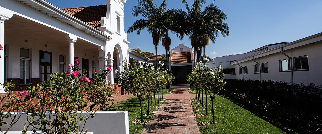 The rose garden and brick pathway between the hospital wings.