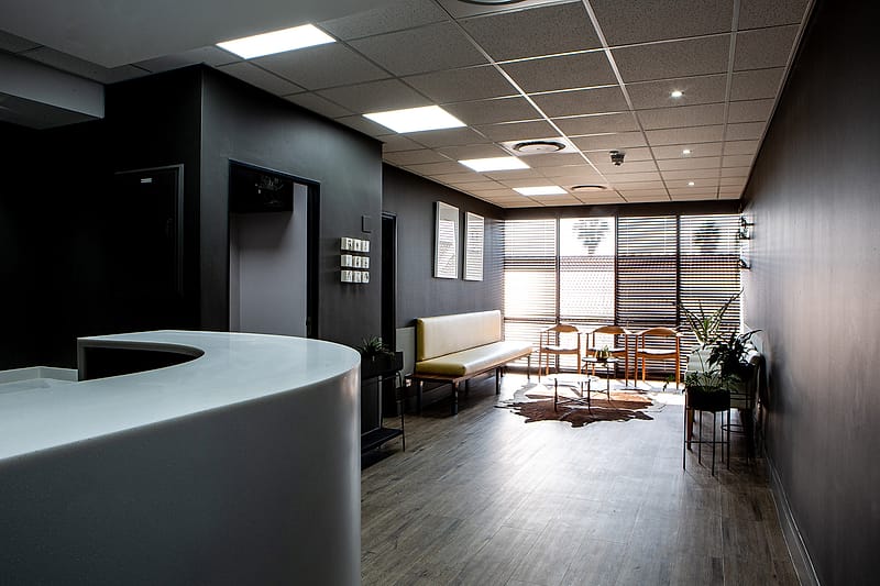 The curved timber reception counter with the waiting room beyond.